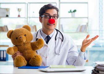 Funny pediatrician with toy in the hospital clinic