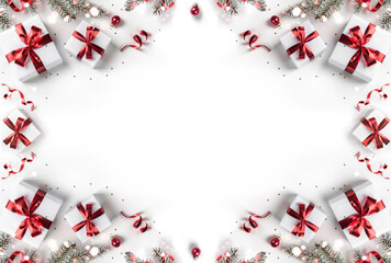 Wall Mural - Creative frame made of Christmas fir branches, gift boxes, red decoration, sparkles and confetti on white background. Xmas and New Year holiday, bokeh, light. Flat lay, top view