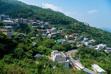 Poster - landscape view of JiuFen Village with mountain residental buildings and blue sky.