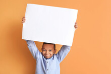 Little African-American Boy With Blank Poster On Color Background