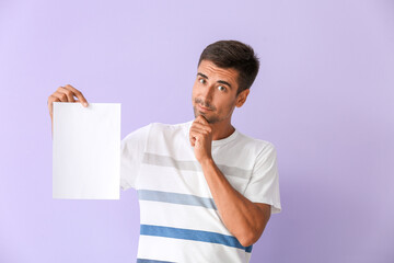 Wall Mural - Young man with blank paper sheet on color background