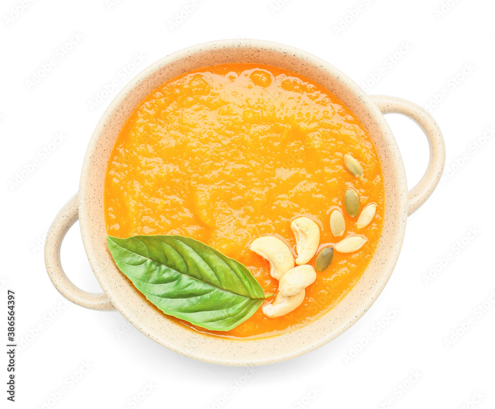 Tasty pumpkin cream soup in pot on white background