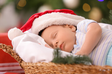 Sticker - Cute little baby sleeping in basket at home on Christmas eve