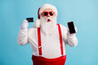 © deagreez - Portrait of his he attractive amazed white-haired Santa holding in hand demonstrating credit card gadget order shop buy good product cash back isolated bright vivid shine vibrant blue color background