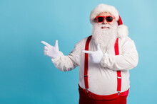 Photo Of Pensioner Grandfather Grey Beard Direct Finger Empty Space Suggest Christmas Decoration Sale Wear Red Santa Costume Suspenders Spectacles White Cap Isolated Blue Color Background