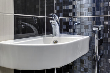 Sticker - water tap sink with faucet in expensive loft bathroom. detail of a corner shower cabin with wall mount shower attachment