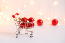Grocery Basket With Red Christmas Tree Toys, A Banner With A Copy Space. Christmas Shopping Online. Winter Holiday Sales, Seasonal Sales, Black Friday, Christmas, Discounts	