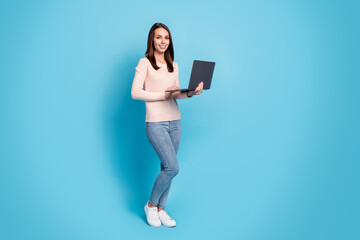 Wall Mural - Full length body size profile side view of her she nice attractive pretty cheerful girl holding in hands using laptop browsing web isolated over bright vivid shine vibrant blue color background