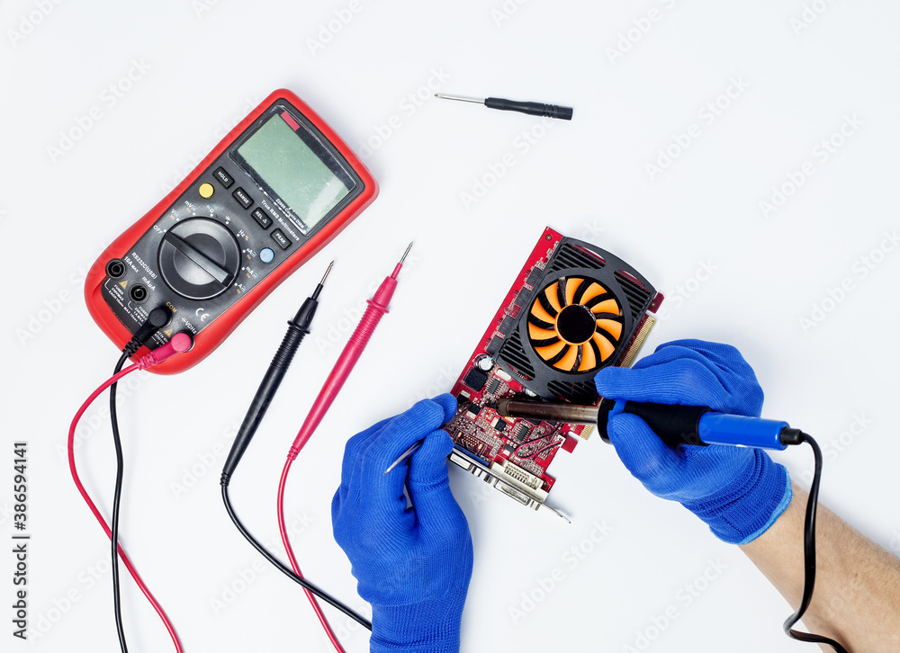 Hands of computer engineer doing repair damaged graphics card on ...