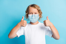 Photo Of Positive Boy Show Thumb Up Sign Wear Respirator Casual Style Outfit Isolated Over Blue Color Background