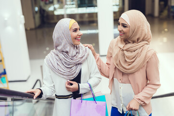 Young Arabian Women with Packages Standing in Mall