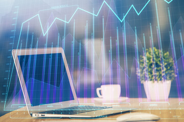 Stock market graph and table with computer background. Double exposure. Concept of financial analysis.