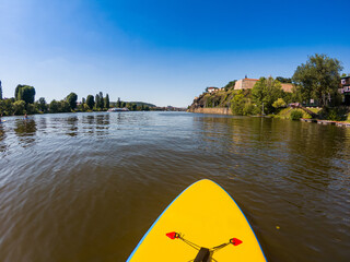 Paddleboarding in Vltava - Moldau river in Prague under Vysehrad fortress