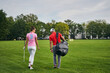 © Viacheslav Yakobchuk - Female golfer and her trainer walking on the grass