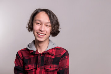 Handsome, mixed-race teen smiling happily 