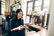 © dodotone - Young adult asian woman hand holding a joy controller wear headset and play game at home