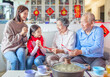 © Tom Wang - happy asian family celebrating chinese new year at home