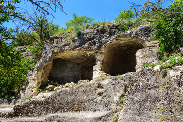 Wall Mural - Ancient cave 'houses' in medieval city-fortress Chufut-Kale, Bakhchisaray, Crimea. These kind of 'buildings' were used for living, storage or even public places