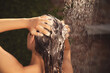 © New Africa - Woman washing hair in outdoor shower on summer day, closeup