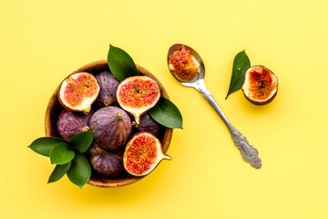 Fresh ripe figs in a bowl with leaves. Mediterranean fruit background