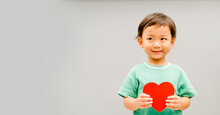 Child Hands Holding Red Heart For Share Donate.Health Care Pediatric.family Insurance.World Heart Day, World Health Day,CSR Responsibility, Adoption Foster Kids.Worship With Faith.Banner Background.