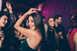 © deagreez - Photo of happy girl dancing at dance floor with friends chilling relaxing together enjoying music at corporate new year party with neon lights