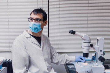 Male Scientist Using Microscopy in Laboratory