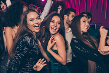 photo of cheerful laughing happy beautiful girls wearing fashionable dress dancing at party in night