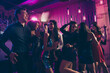 © deagreez - Photo portrait of guys and girl dancing together at nightclub laughing chilling having good mood