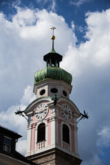 Church tower of the Spitalkirche in Innsbruck with blue sky and clouds