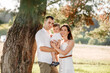 © Andriy Medvediuk - dad, mom hugging son outdoors in the park. The concept of summer holiday. Mother's, father's, baby's day. Family spending time together on nature. Family look. selective focus