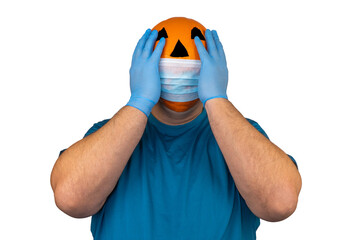 Halloween pumpkin in a medical respiratory bandage face. Surgical protective mask. person with orange evil mask.