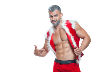 Sexy Santa Claus. Bodybuilder young handsome santa clause smile shows off abs cubes at New Years eve and Christmas winter holiday white background