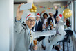 © Drazen - Happy business colleagues taking selfie on Christmas party in the office.