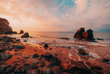 Wall Mural - Colorful sunset on the rocky sea coast