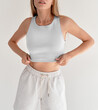 © AlexGo - girl wears white crop top and white shorts. studio shooting of young woman in casual street wear