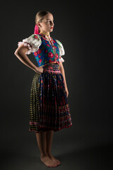 portrait of the beautiful young woman in traditional slovak folk dress