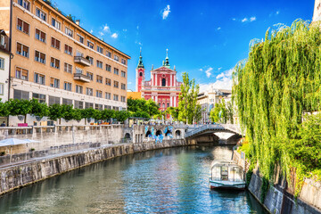 Wall Mural - Ljubljana City Center during a Sunny Day overlooking Lublanka river and Beautiful Franciscan Church