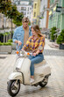 © zinkevych - Man instructing woman to ride a scooter