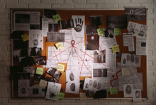 Detective Board With Fingerprints, Photos, Map And Clues Connected By Red String On White Brick Wall