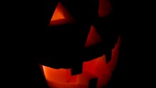 Spooky Halloween Vintage Jack-o-lantern Pumpkin With Flickering Candlelight Coming From Eyes And Mouth