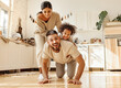 © JenkoAtaman - Happy multiracial family playing in kitchen.