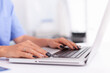 © DC Studio - Close up of doctor hands typing on a laptop in a medical office. Health practitioner searching in hospital database using laptop in hospital cabinet, keyboard, job.