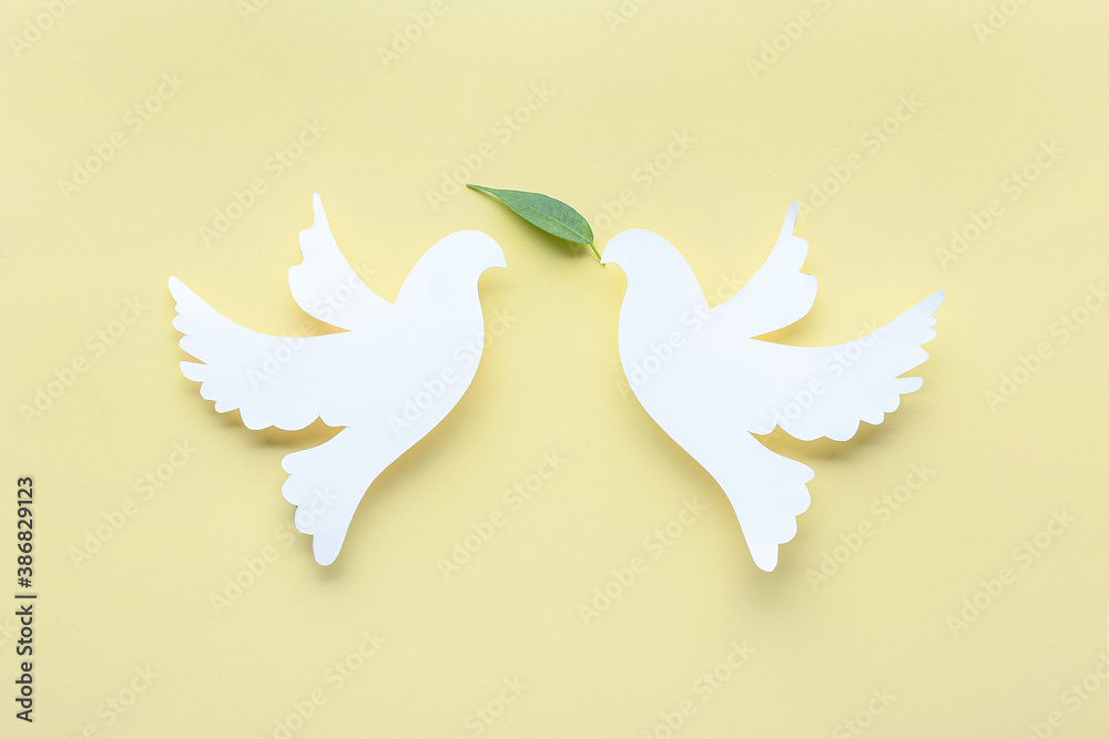 Paper doves on color background. International Day of Peace