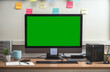 © THANANIT - Computer desktop with Stationery and device showing the green screen via video conference when Coronavirus outbreak, Covid-19 pandemic,home office and new normal Concept