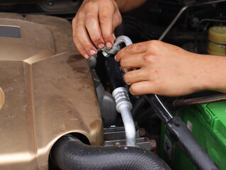 Mechanic working on the engine in an auto repair shop