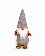 Scandinavian Santa Claus Or Gnome Figurine Isolated On White Background, Fairy Skier Elf In Gray Cap And Red Suit