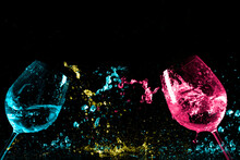 Glasses Of Wine Or Champagne With The Abstract Colorful Water Splash On Dark Background