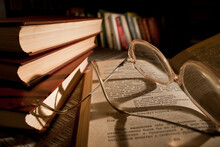 Old Glasses On The Book