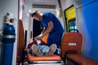 © Anna Kosolapova - Medical student having an exam, giving an oxygen mask to his patient in an ambulance car.